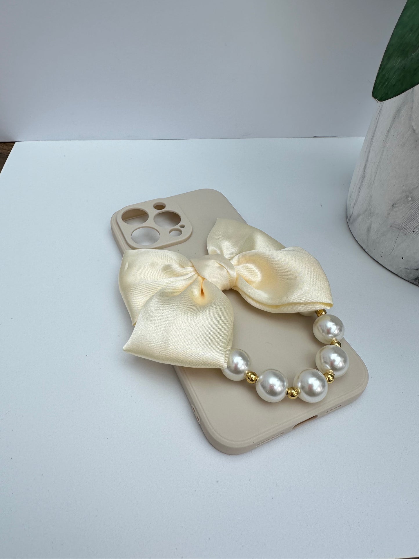Bowtique Cream Phone Case with Pearl Hand Strap