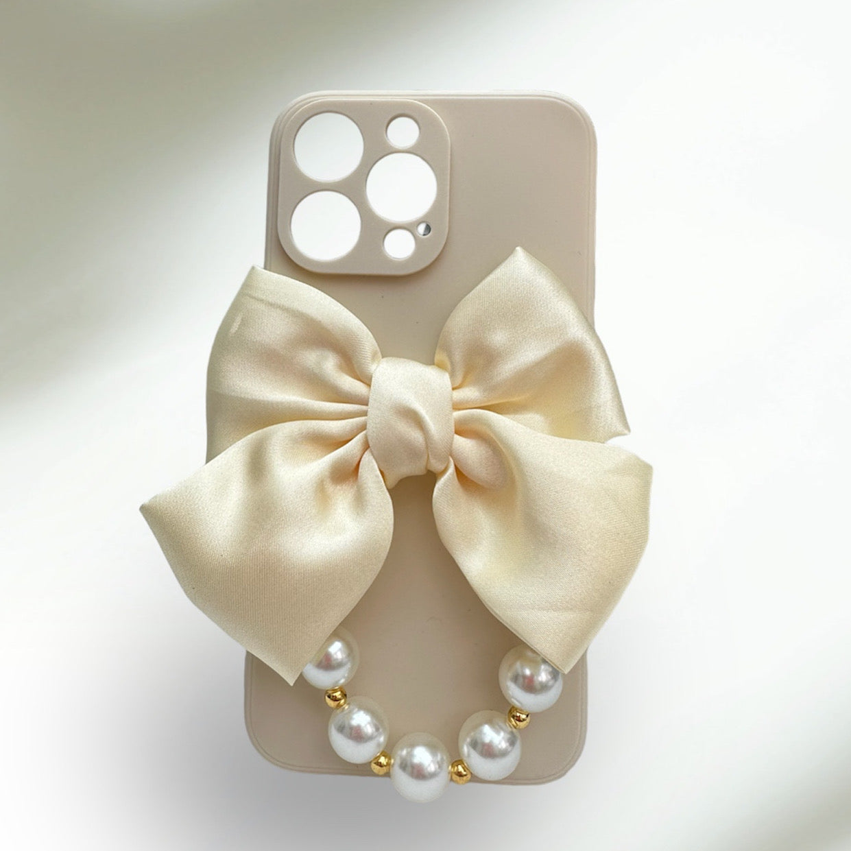 Bowtique Cream Phone Case with Pearl Hand Strap